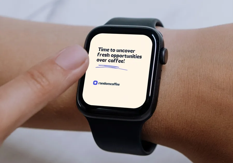 A smartwatch on a wrist showing the tagline Time to uncover fresh opportunities over coffee! with the RandomCoffee logo